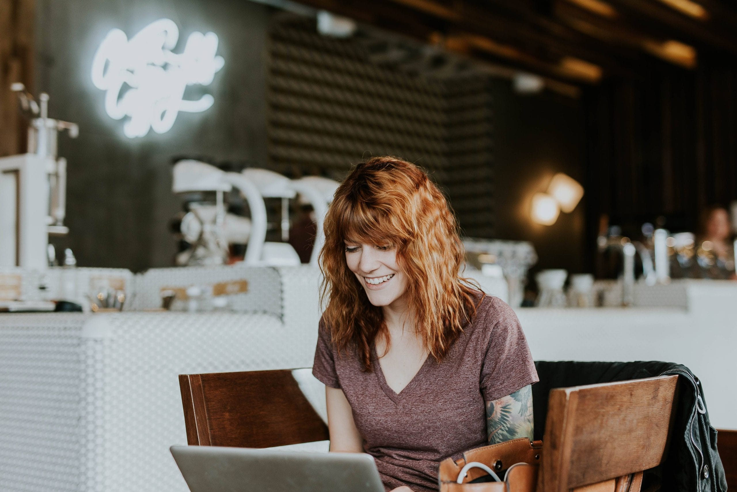 Tattooed woman with laptop